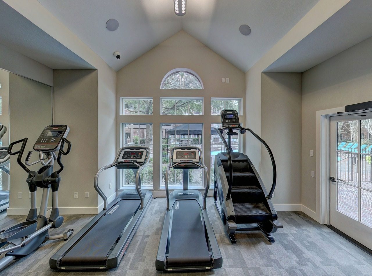 Small cardio room with treadmills, an elliptical and a stair climber